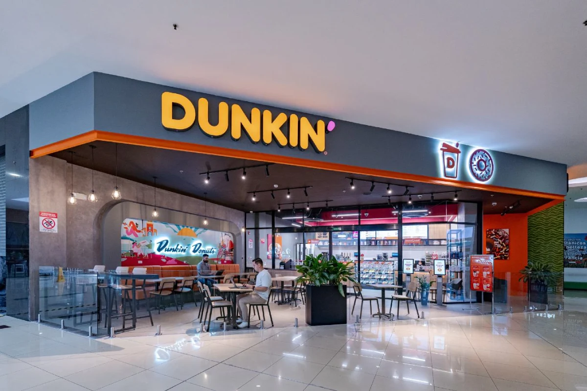 Dunkin Donuts - Corner retail storefront design with illuminated signage and glass facade - Contract Workplaces.webp